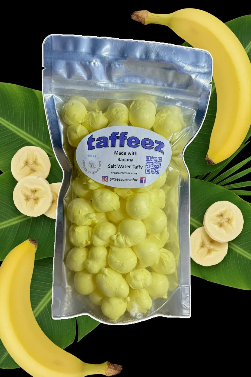 Bag of banana freeze-dried salt water taffy with fresh bananas and banana slices on leaves