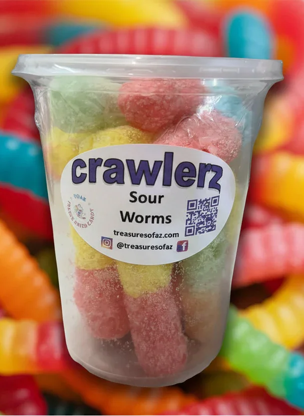 Clear cup of colorful sour gummy worms labeled 'crawlerz' with sugary coating