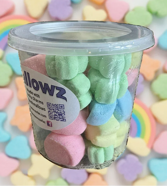 Tub of colorful freeze-dried marshmallows with pastel candy hearts and rainbows in background