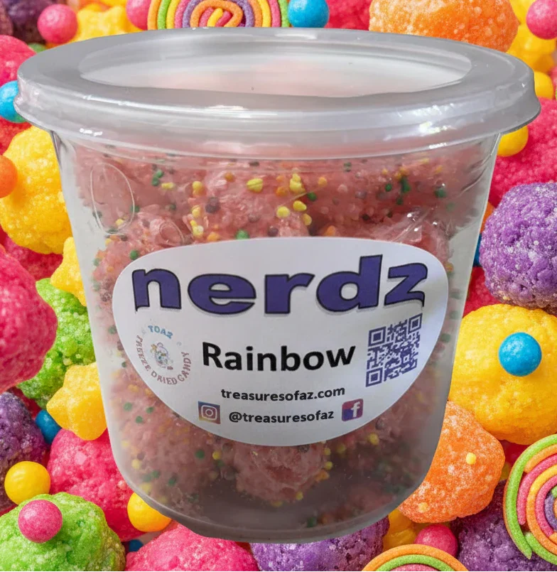 Container of freeze-dried rainbow Nerdz candy surrounded by colorful crunchy sweets